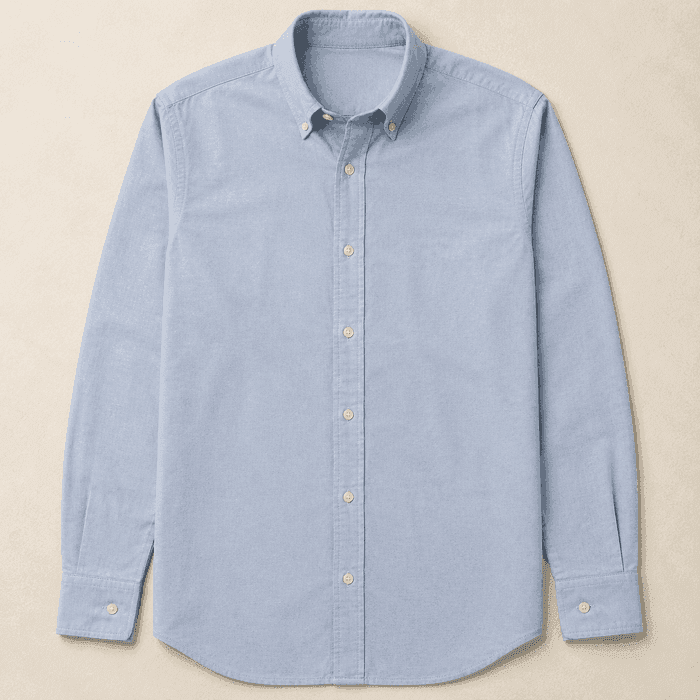 A pale blue cotton oxford shirt laid flat and buttoned.
